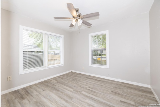 spare room with light hardwood / wood-style flooring and ceiling fan