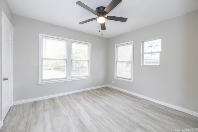 unfurnished room with ceiling fan and light wood-type flooring