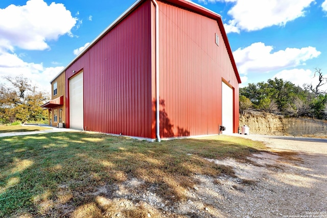 view of outbuilding with a garage and a lawn