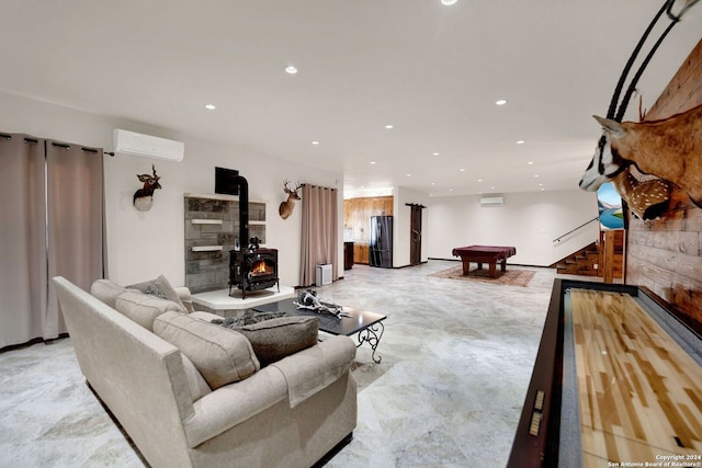 living room featuring a wood stove, pool table, and an AC wall unit