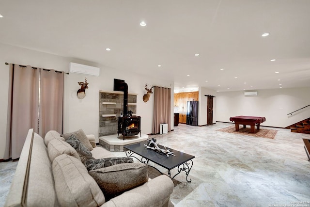 living room with a wood stove, an AC wall unit, and billiards