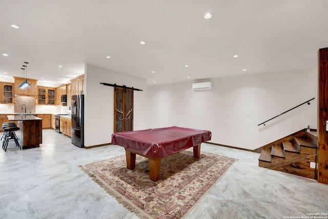 game room featuring a barn door, an AC wall unit, and billiards