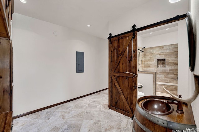 bathroom featuring vanity, toilet, tiled shower, and electric panel
