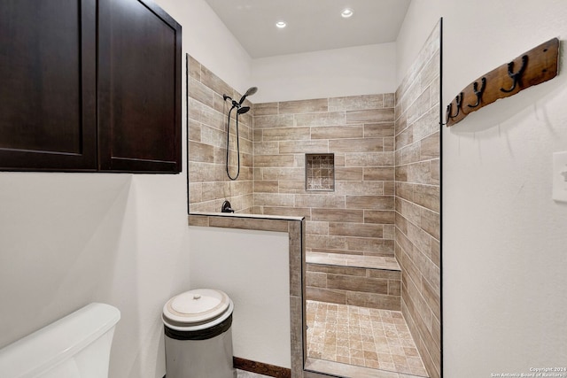 bathroom featuring toilet and tiled shower