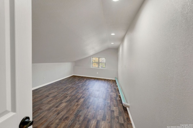 bonus room with dark hardwood / wood-style flooring and lofted ceiling