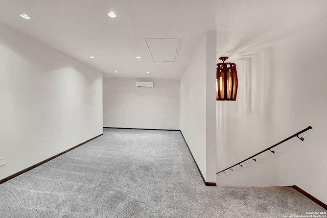 carpeted spare room featuring an AC wall unit