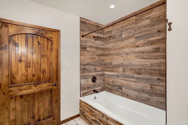 bathroom with tile patterned flooring and tiled shower / bath