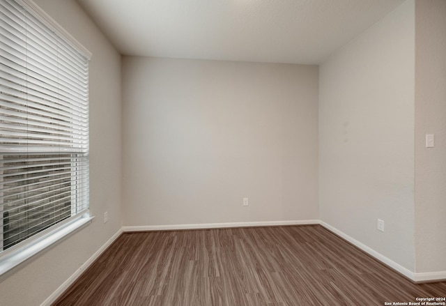 empty room with dark hardwood / wood-style floors