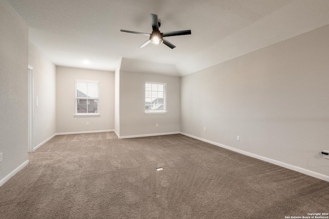 unfurnished room featuring carpet flooring, ceiling fan, and lofted ceiling