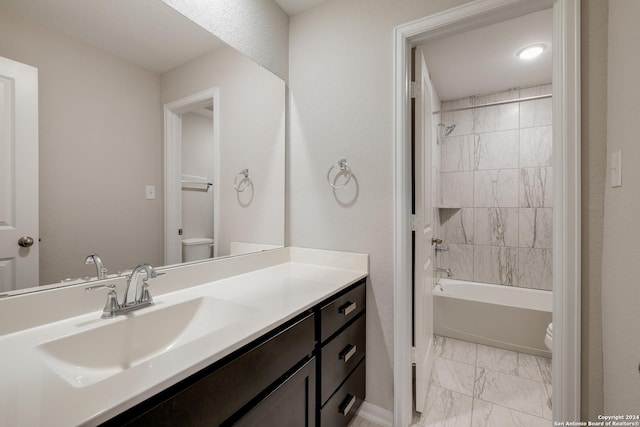 full bathroom with vanity, toilet, and tiled shower / bath