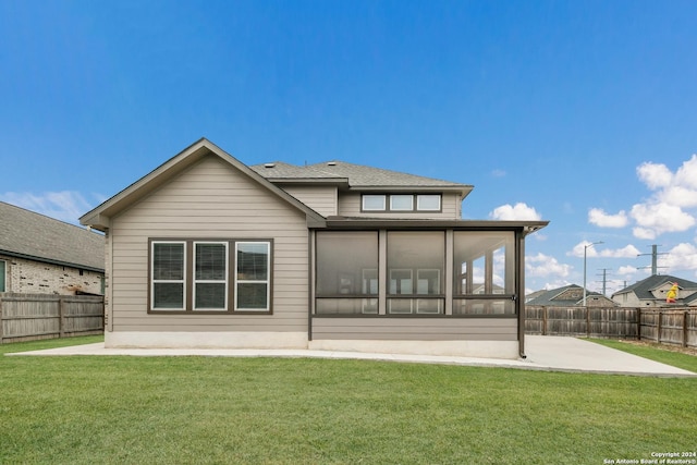 back of property featuring a sunroom, a yard, and a patio