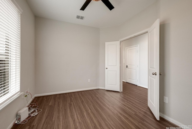 unfurnished bedroom featuring ceiling fan and dark hardwood / wood-style floors