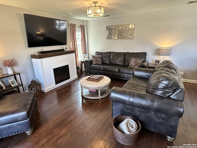 living room with dark hardwood / wood-style floors and a notable chandelier