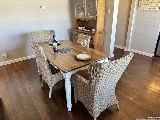 dining room with dark hardwood / wood-style flooring