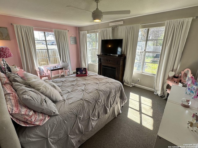 bedroom with multiple windows, ceiling fan, and carpet