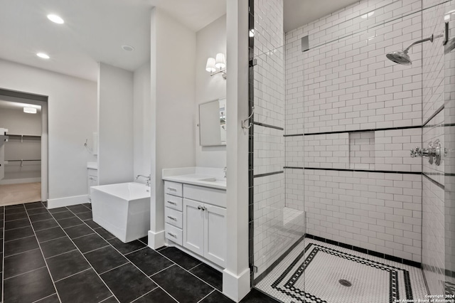 bathroom featuring tile patterned flooring, vanity, and shower with separate bathtub