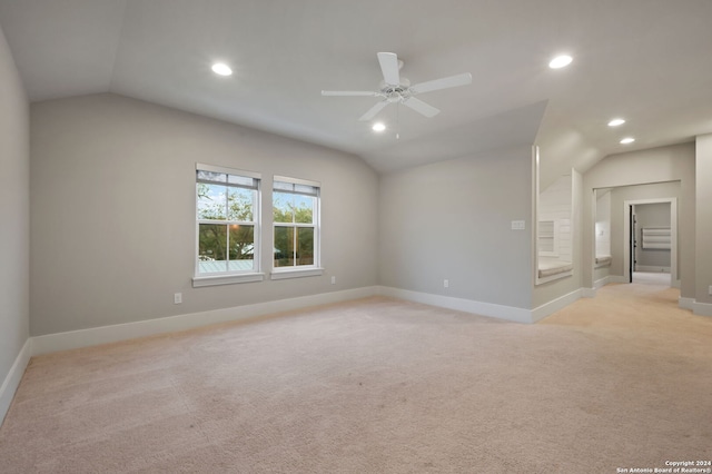 carpeted empty room featuring ceiling fan and vaulted ceiling