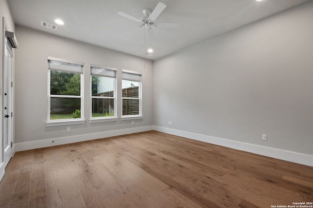 unfurnished room with ceiling fan and light wood-type flooring