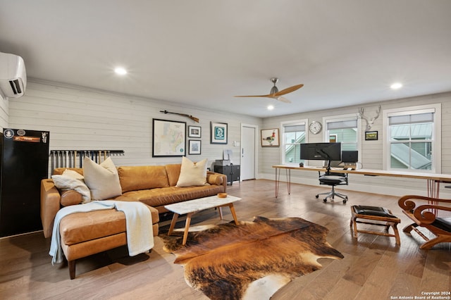 living room featuring a wall mounted air conditioner, hardwood / wood-style floors, and ceiling fan