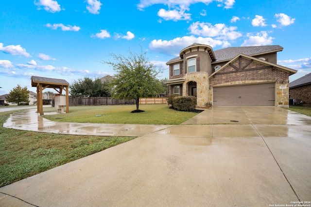 view of front of house featuring a garage and a front lawn