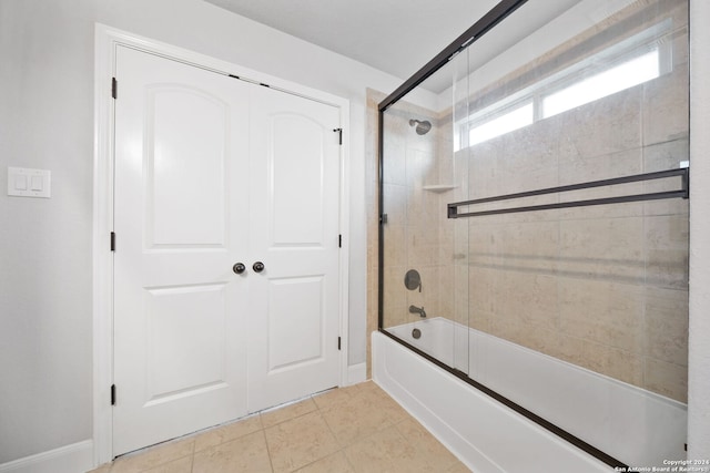 bathroom featuring tile patterned floors and combined bath / shower with glass door