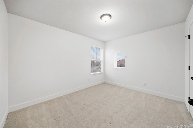 spare room with light colored carpet