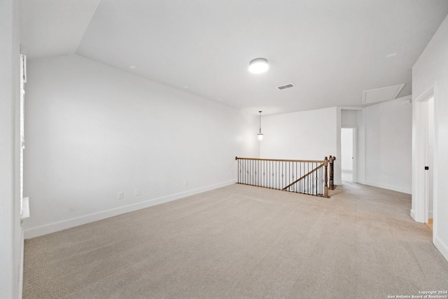 unfurnished room with light carpet and lofted ceiling