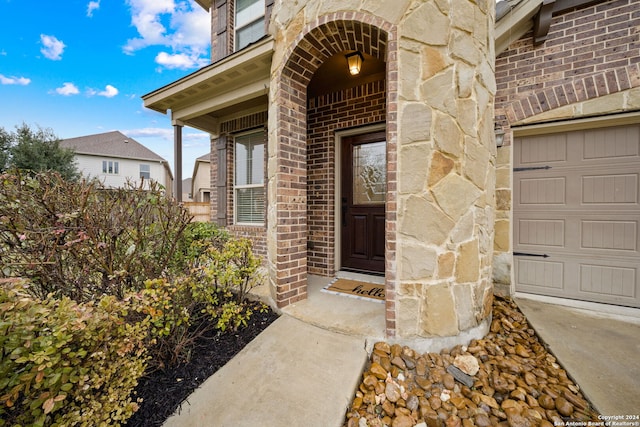 view of exterior entry with a garage