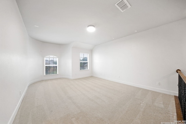 spare room featuring light colored carpet