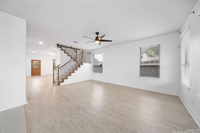 unfurnished living room with ceiling fan and light hardwood / wood-style flooring