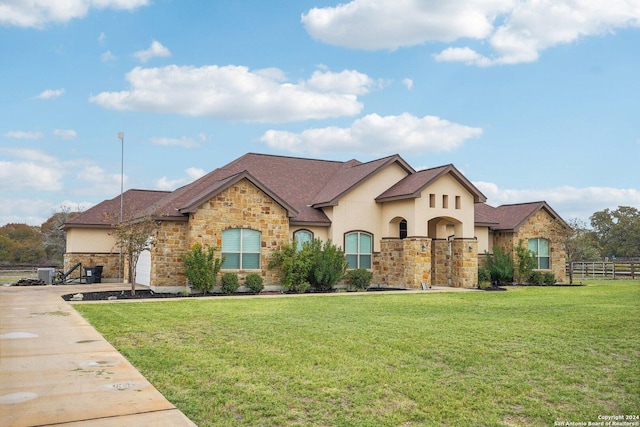 view of front of home featuring a garage and a front lawn