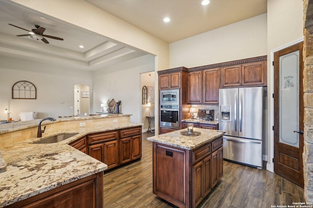 kitchen featuring a center island, sink, dark hardwood / wood-style floors, ceiling fan, and stainless steel appliances