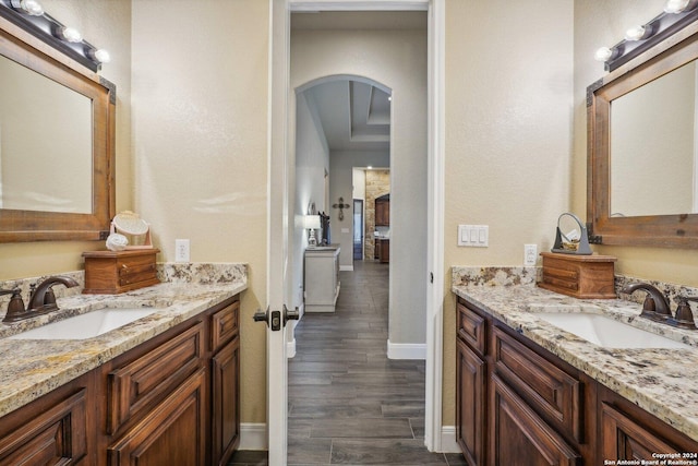 bathroom with vanity and wood-type flooring