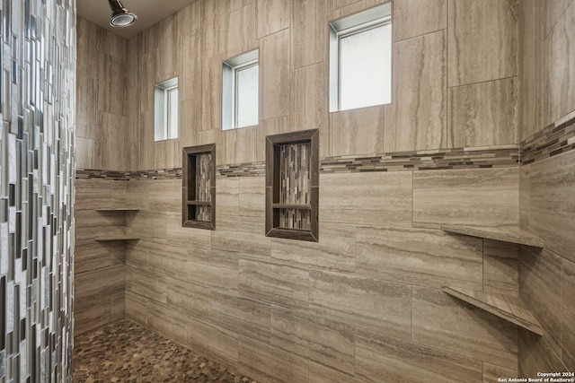 bathroom with tiled shower