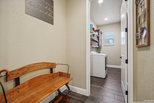 washroom featuring washer / dryer, dark hardwood / wood-style flooring, and a textured ceiling