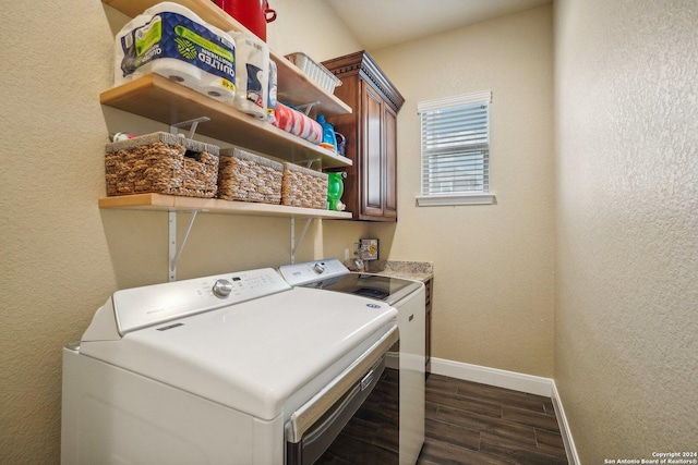 laundry area featuring dark hardwood / wood-style floors, cabinets, and washing machine and clothes dryer