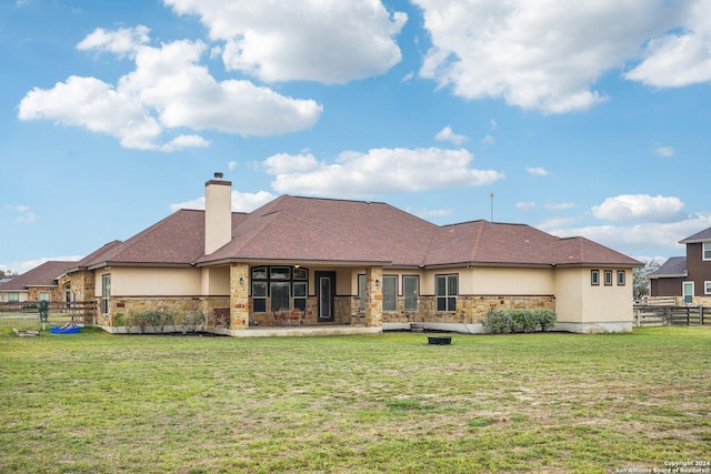 rear view of house with a yard