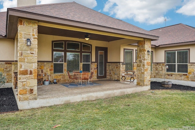 back of property with a patio, ceiling fan, and a lawn