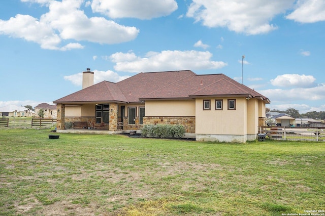 back of house with a yard