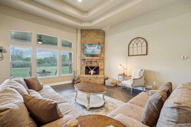 living room featuring ceiling fan, a fireplace, and a wealth of natural light