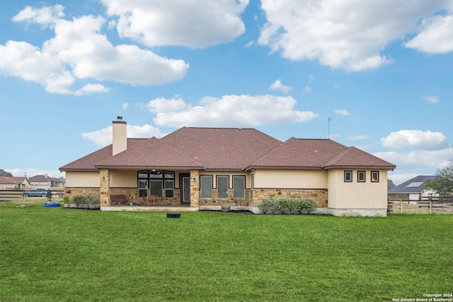 back of house with a lawn