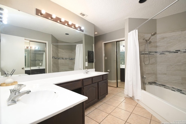 bathroom featuring tile patterned flooring, vanity, shower / bath combo, and a textured ceiling