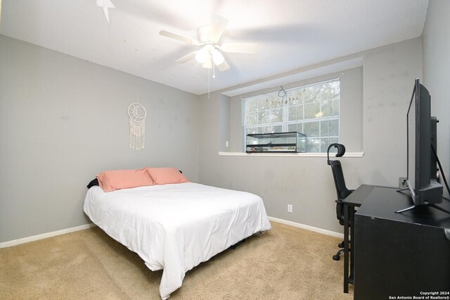 bedroom with light carpet and ceiling fan