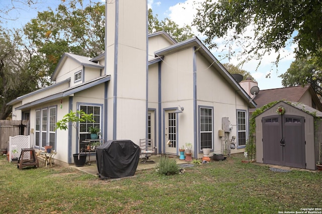 rear view of property with a patio, a storage shed, and a lawn