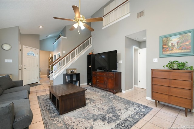 living room featuring ceiling fan, light tile patterned floors, and high vaulted ceiling