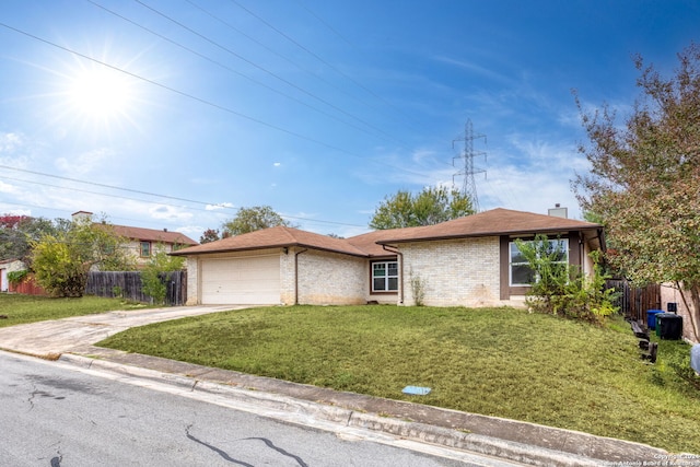 ranch-style home featuring a garage and a front lawn