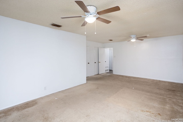 carpeted spare room featuring a textured ceiling