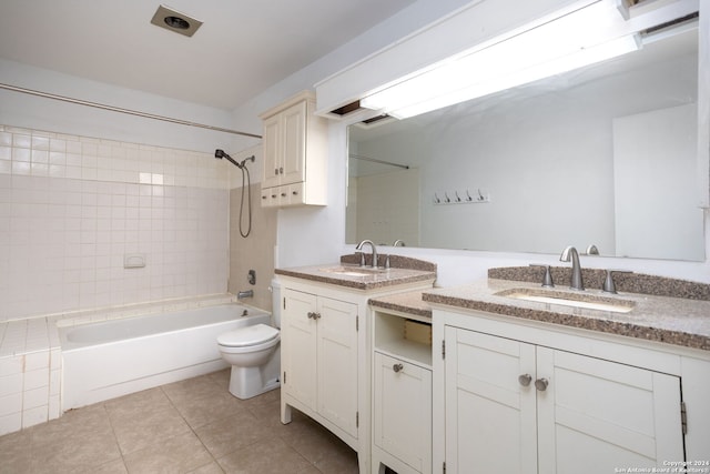 full bathroom with toilet, vanity, tile patterned floors, and tiled shower / bath combo