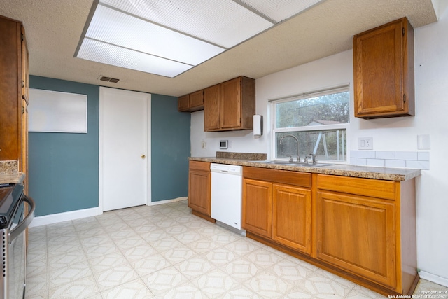 kitchen featuring dishwasher, stainless steel electric stove, and sink