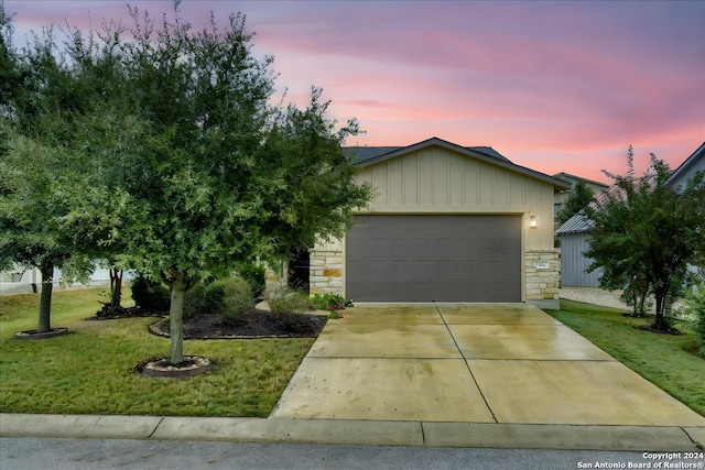 ranch-style home with a lawn